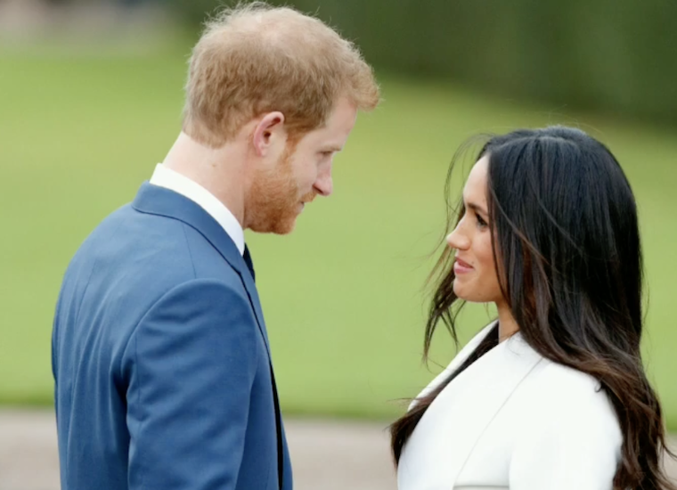 prince harry looking at meghan markle